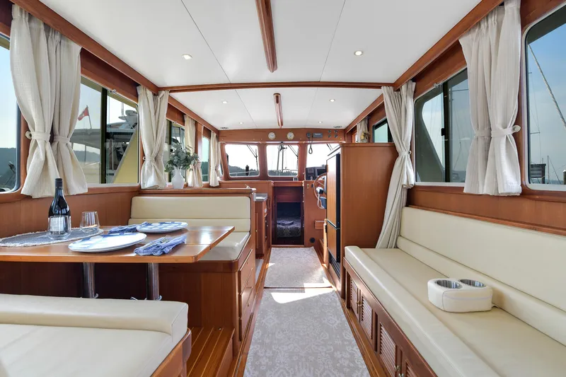 Island Harmony Yacht Photos Pics Luxurious interior of 2012 North Pacific NP 38 Sedan yacht with elegant dining area.