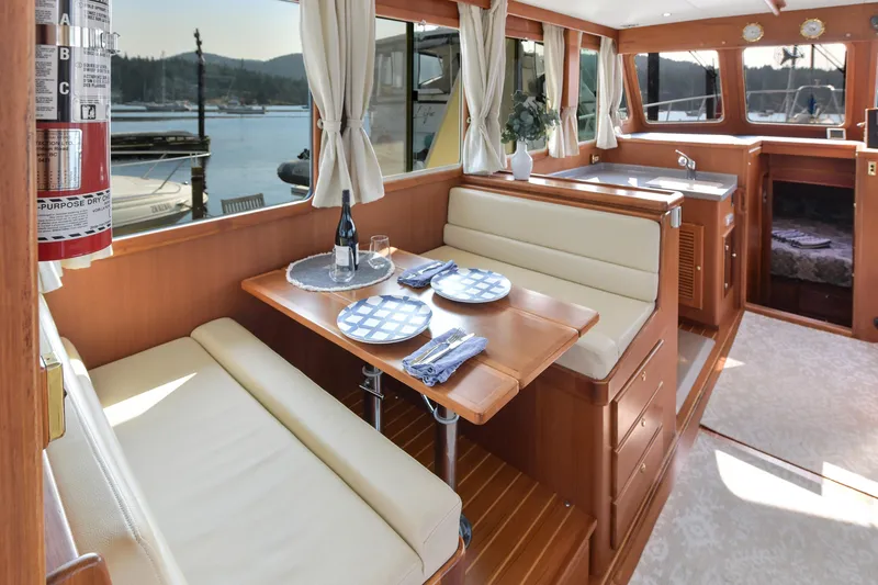 Island Harmony Yacht Photos Pics Interior of 2012 North Pacific NP 38 Sedan with dining area and scenic view.