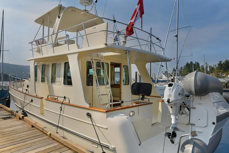 Island Harmony Yacht Photos Pics 2012 North Pacific NP 38 Sedan yacht docked at marina with Canadian flag.