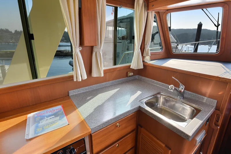 Island Harmony Yacht Photos Pics Interior of 2012 North Pacific NP 38 Sedan yacht with kitchenette and window view.