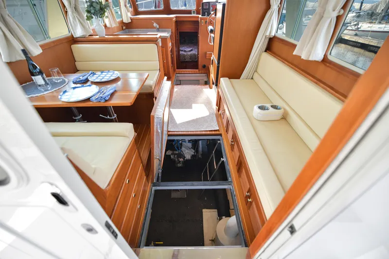 Island Harmony Yacht Photos Pics Interior of 2012 North Pacific NP 38 Sedan yacht with elegant seating and dining area.