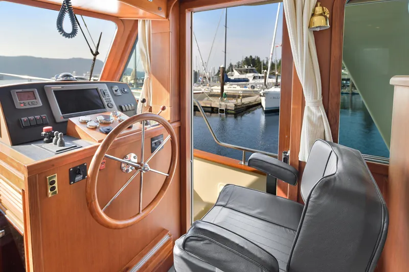 Island Harmony Yacht Photos Pics Interior of 2012 North Pacific NP 38 Sedan yacht with steering wheel and control panel.