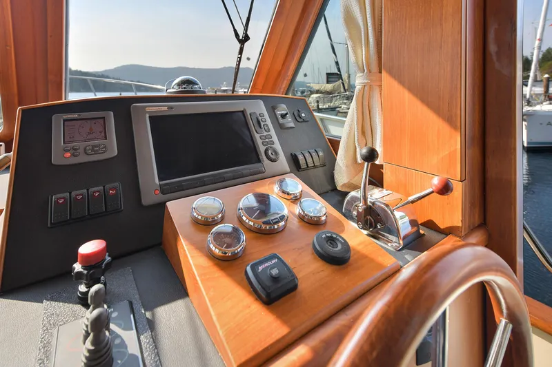 Island Harmony Yacht Photos Pics 2012 North Pacific NP 38 Sedan helm with navigation controls and instruments.