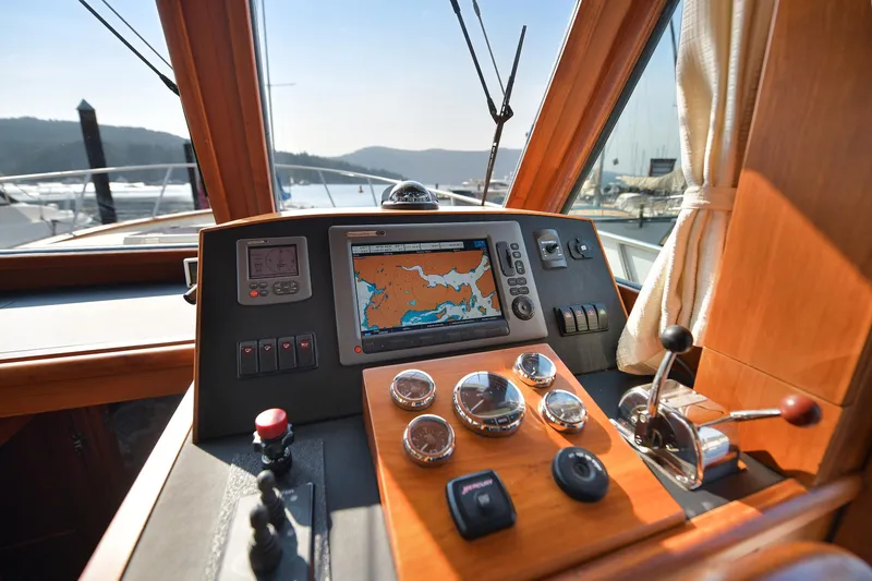 Island Harmony Yacht Photos Pics 2012 North Pacific NP 38 Sedan helm with navigation controls and scenic marina view.