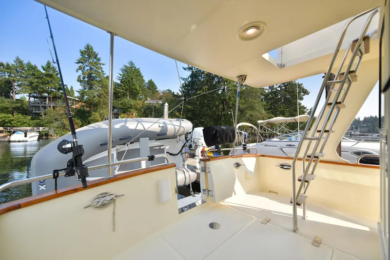 Island Harmony Yacht Photos Pics 2012 North Pacific NP 38 Sedan yacht deck with ladder and scenic marina view.