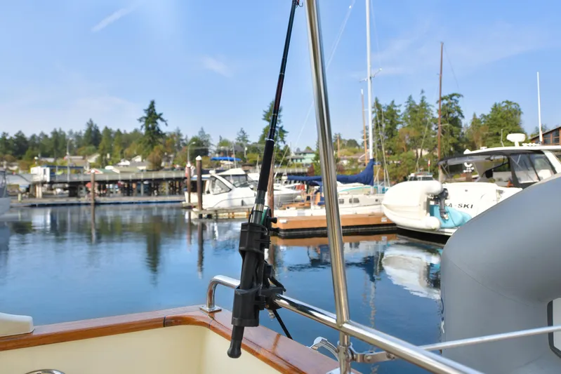 Island Harmony Yacht Photos Pics Fishing rod on a 2012 North Pacific NP 38 Sedan boat in a marina.