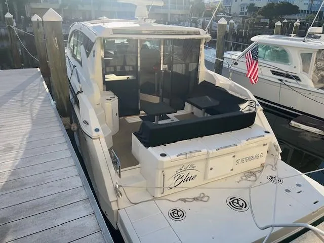  Yacht Photos Pics 2018 Cruisers Yachts 42 Cantius docked, featuring spacious seating and American flag.