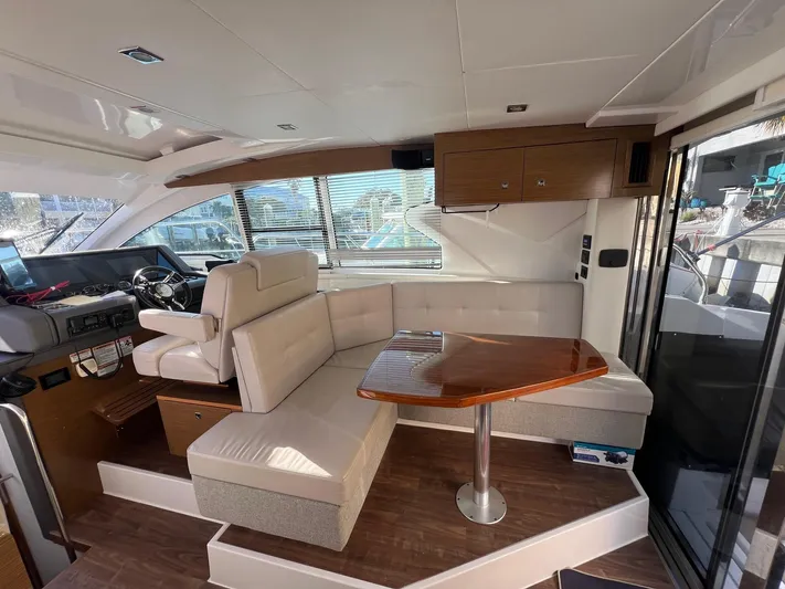  Yacht Photos Pics Interior of 2018 Cruisers Yachts 42 Cantius with seating and wooden table.