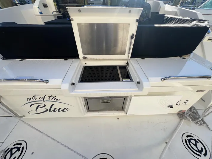  Yacht Photos Pics 2018 Cruisers Yachts 42 Cantius deck with grill and storage, labeled "Out of the Blue."