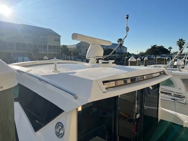  Yacht Photos Pics 2018 Cruisers Yachts 42 Cantius boat docked, featuring radar and antenna on the roof.