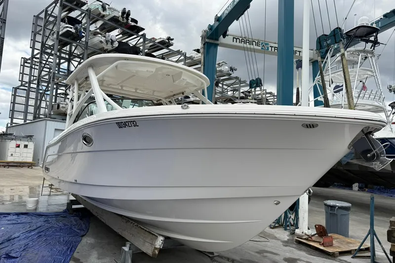  Yacht Photos Pics 2024 Robalo R317 Dual Console boat in a marina, ready for launch.