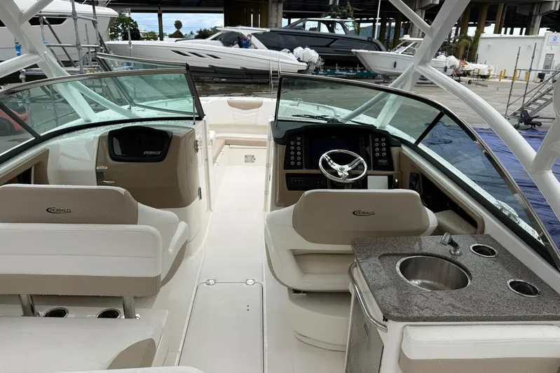  Yacht Photos Pics 2024 Robalo R317 Dual Console boat interior with helm, seating, and sink.