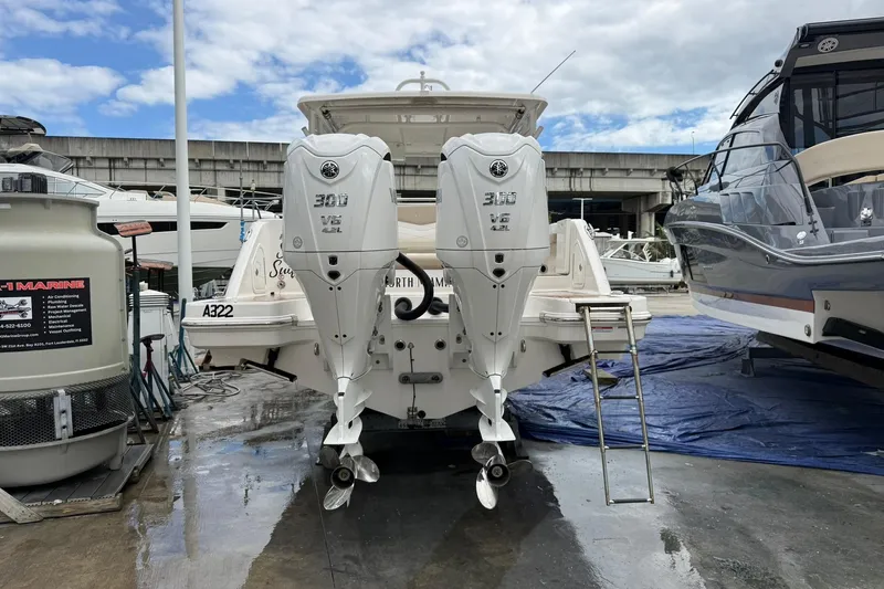  Yacht Photos Pics 2024 Robalo R317 Dual Console boat with twin 300 V6 engines at a marina.