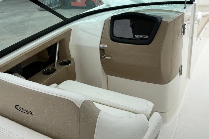 Yacht Photos Pics 2024 Robalo R317 Dual Console interior with beige seating and cup holders.