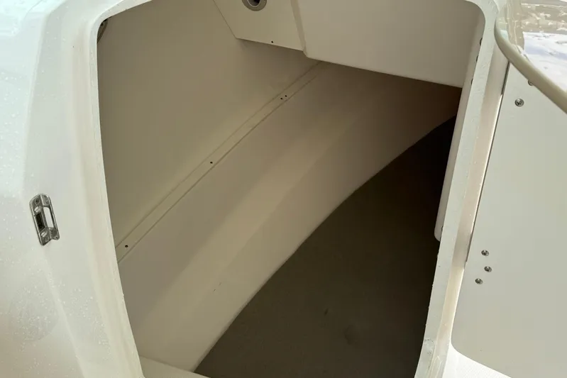  Yacht Photos Pics 2024 Robalo R317 Dual Console storage compartment interior view.