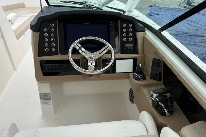  Yacht Photos Pics 2024 Robalo R317 Dual Console boat cockpit with steering wheel and control panel.