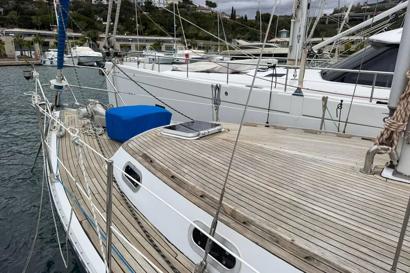 Giksea Yacht Photos Pics 1989 Franchini Atlantide 42 yacht with wooden deck, docked in a marina.