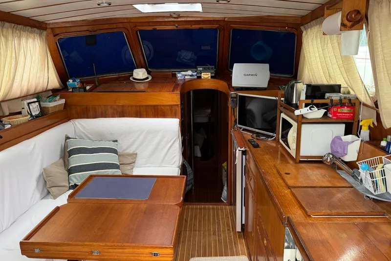 Giksea Yacht Photos Pics Interior of 1989 Franchini Atlantide 42 yacht with wooden furnishings and navigation equipment.