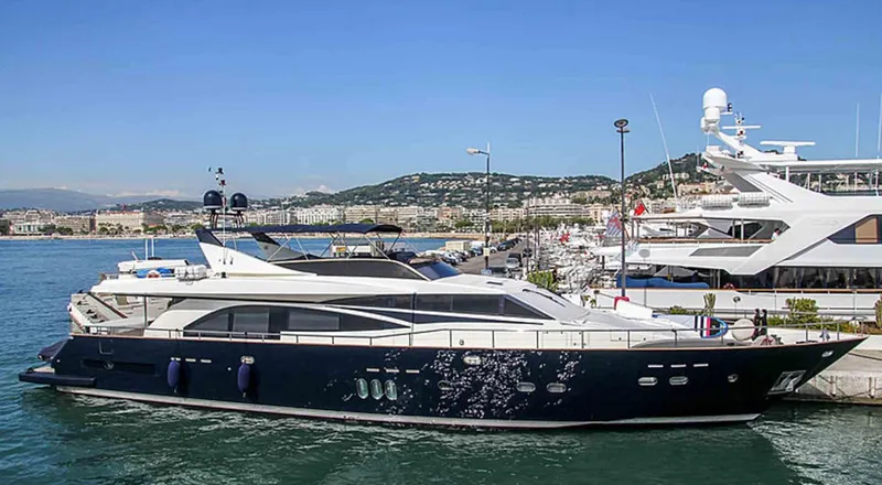 Yacht Photos Pics Luxury 2006 Couach 3000 Fly yacht docked in a scenic marina.