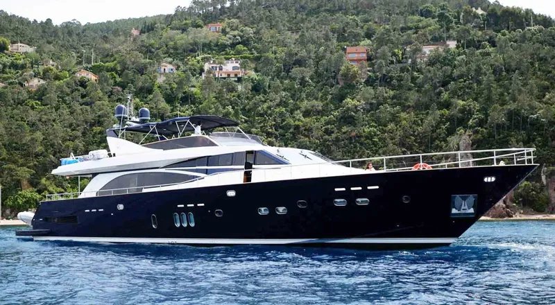  Yacht Photos Pics Luxury 2006 Couach 3000 Fly yacht cruising near lush, green coastline.