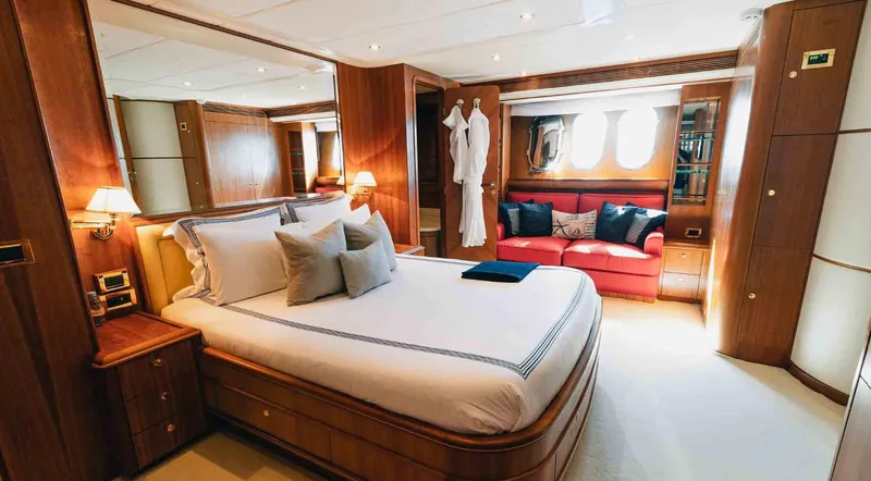  Yacht Photos Pics Luxurious bedroom interior of 2006 Couach 3000 Fly yacht with elegant wood finishes.