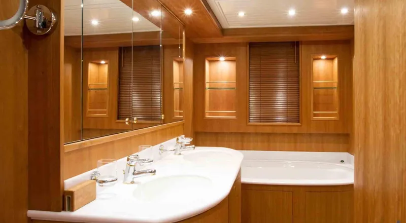  Yacht Photos Pics Luxurious bathroom interior on 2006 Couach 3000 Fly yacht, featuring wood paneling and dual sinks.