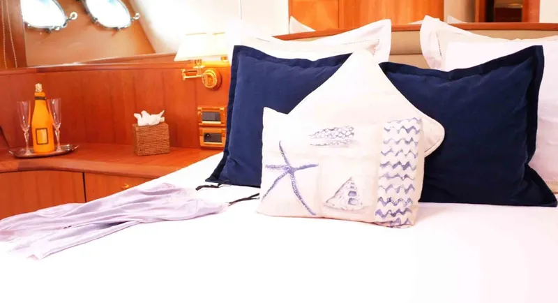  Yacht Photos Pics Luxurious bedroom interior on 2006 Couach 3000 Fly yacht with nautical-themed pillows.