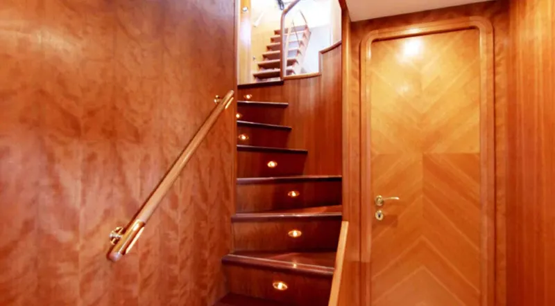  Yacht Photos Pics Luxurious wooden staircase inside 2006 Couach 3000 Fly yacht, featuring elegant lighting.