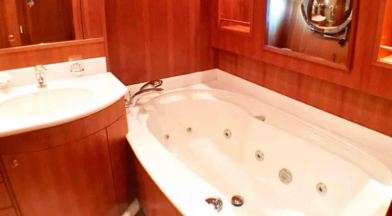  Yacht Photos Pics Luxurious bathroom with jacuzzi tub on 2006 Couach 3000 Fly yacht.