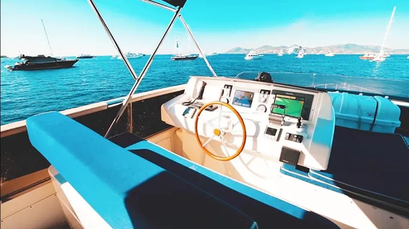  Yacht Photos Pics Helm of 2006 Couach 3000 Fly yacht with ocean view and distant boats.