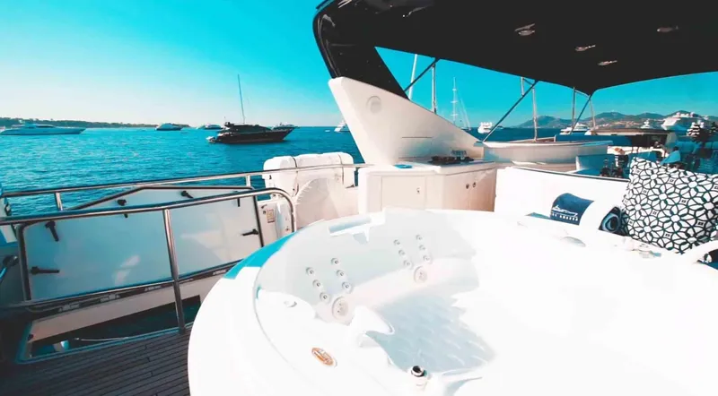  Yacht Photos Pics Luxury yacht Couach 3000 Fly 2006 with jacuzzi on deck, overlooking serene ocean view.