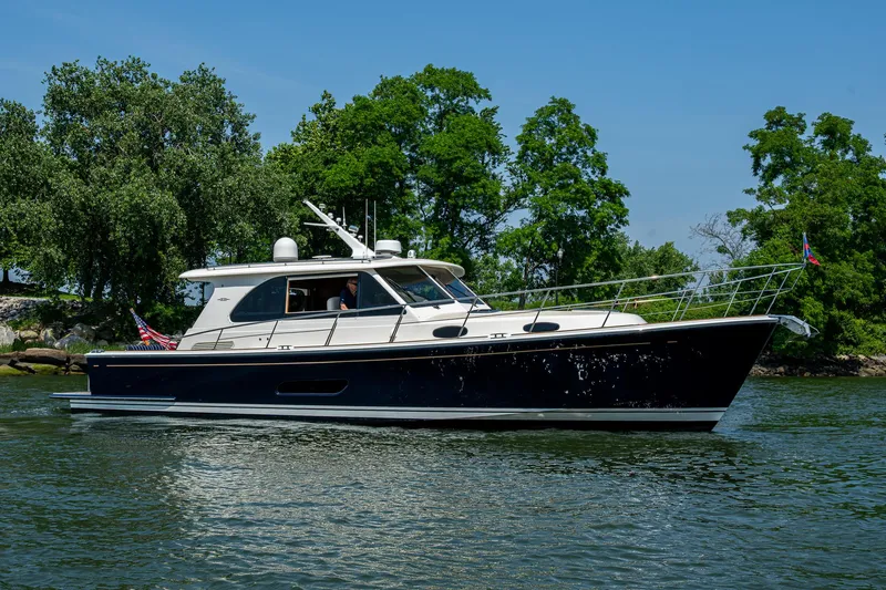 Duet Yacht Photos Pics 2017 Grand Banks 44 Eastbay SX yacht cruising on a serene waterway.