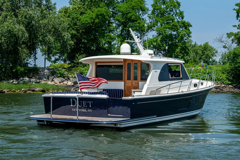 Duet Yacht Photos Pics 2017 Grand Banks 44 Eastbay SX yacht cruising on a scenic waterway.