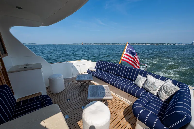 Duet Yacht Photos Pics Luxurious 2017 Grand Banks 44 Eastbay SX yacht deck with striped seating and ocean view.