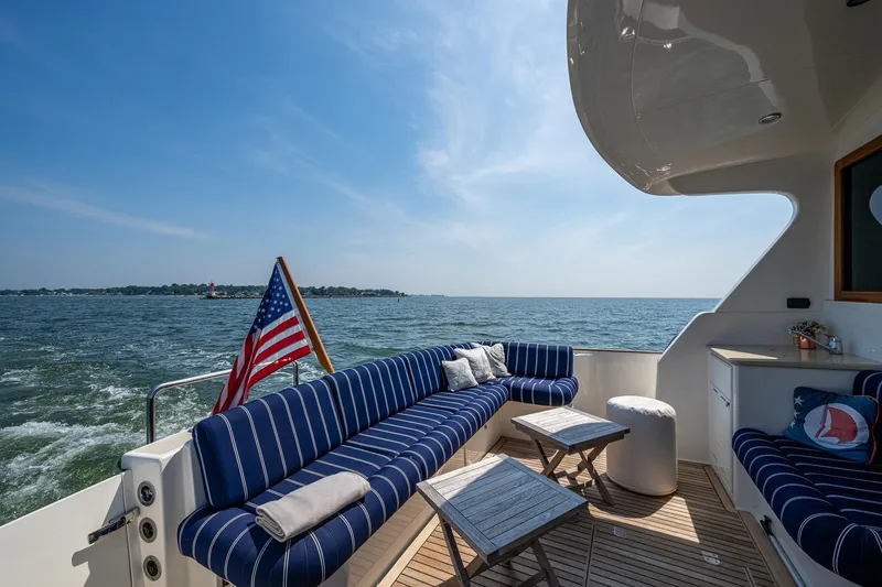 Duet Yacht Photos Pics Luxurious 2017 Grand Banks 44 Eastbay SX yacht deck with striped seating and ocean view.