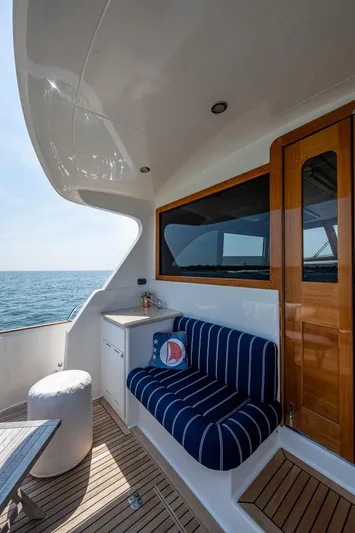 Duet Yacht Photos Pics Luxurious 2017 Grand Banks 44 Eastbay SX yacht deck with striped seating and ocean view.
