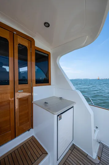 Duet Yacht Photos Pics 2017 Grand Banks 44 Eastbay SX yacht deck with wooden doors and ocean view.