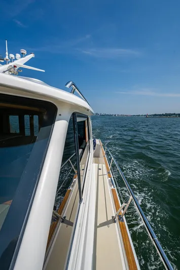 Duet Yacht Photos Pics 2017 Grand Banks 44 Eastbay SX cruising on open water under clear blue skies.