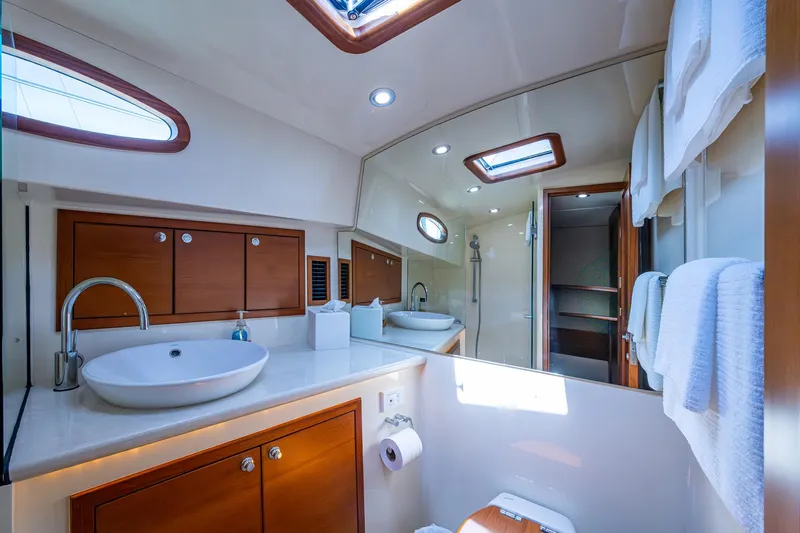 Duet Yacht Photos Pics Luxurious bathroom in 2017 Grand Banks 44 Eastbay SX yacht, featuring modern fixtures and elegant wood cabinetry.