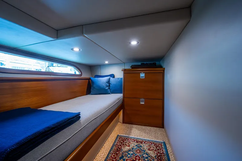 Duet Yacht Photos Pics Cabin interior of 2017 Grand Banks 44 Eastbay SX with cozy bed and wooden storage.