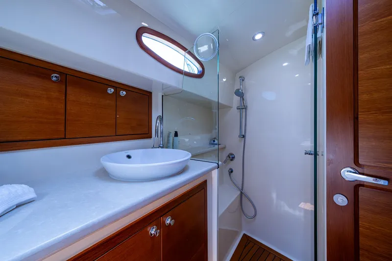 Duet Yacht Photos Pics Luxurious bathroom in 2017 Grand Banks 44 Eastbay SX yacht with modern fixtures and wooden accents.