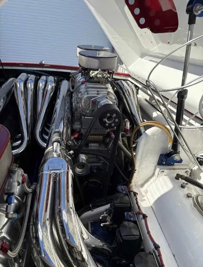  Yacht Photos Pics Engine of a 1994 Apache 47 Fire Water boat with chrome components and detailed mechanics.