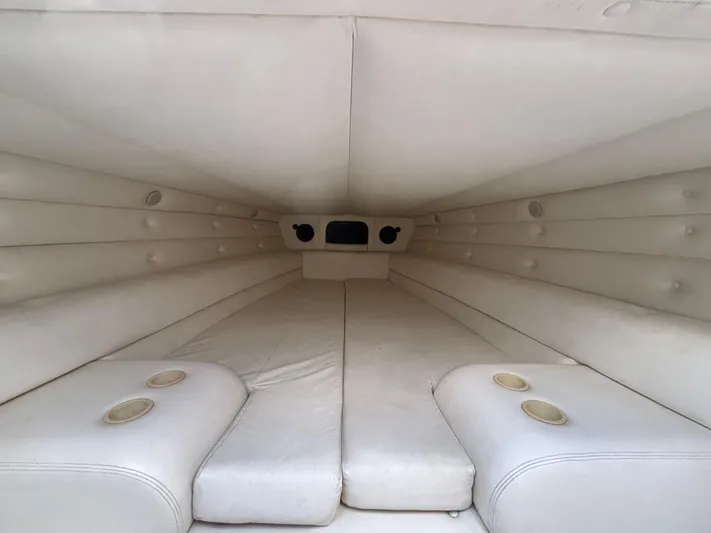  Yacht Photos Pics Interior cabin of a 1994 Apache 47 Fire Water boat, featuring white cushioned seating.