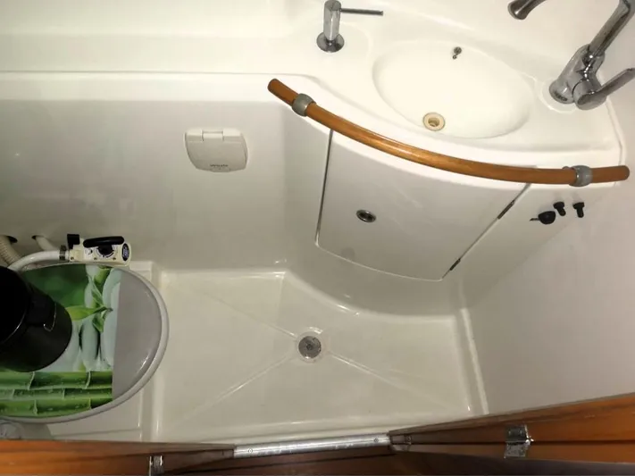 Tortuga Yacht Photos Pics Compact bathroom in a 2001 Lagoon 380 yacht, featuring sink and shower area.