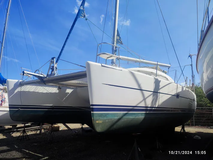 Tortuga Yacht Photos Pics 2001 Lagoon 380 catamaran on land, blue sky background, October 2024.