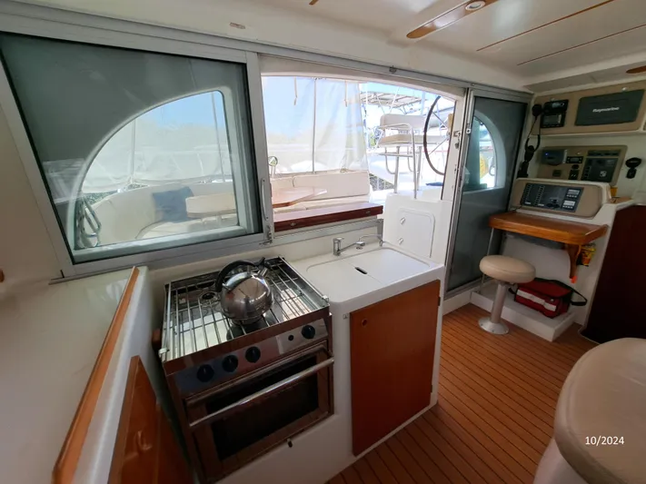 Tortuga Yacht Photos Pics Interior of 2001 Lagoon 380 catamaran with kitchen and navigation area.