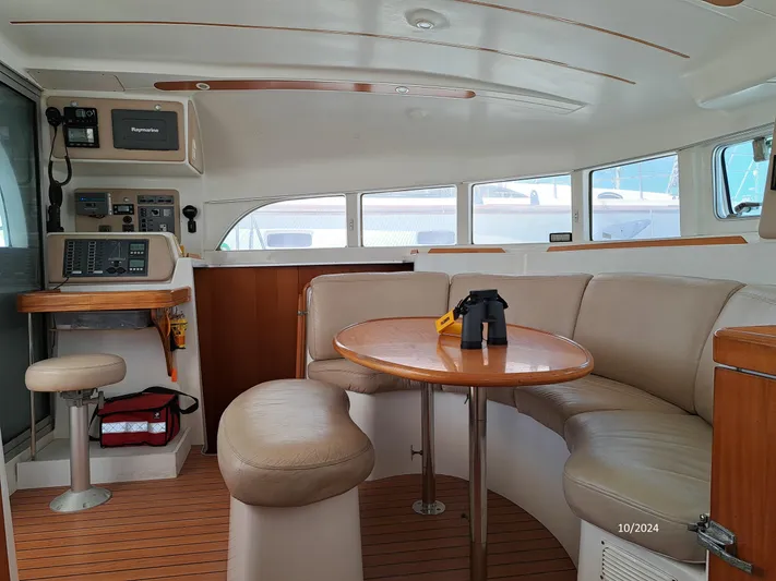 Tortuga Yacht Photos Pics Interior of 2001 Lagoon 380 catamaran with seating area and navigation equipment.