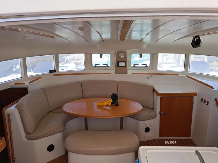 Tortuga Yacht Photos Pics Interior of 2001 Lagoon 380 catamaran with curved seating and round table.