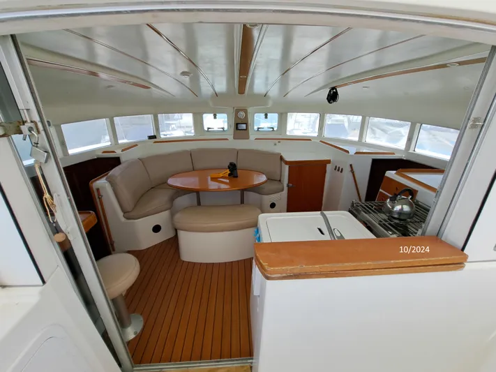 Tortuga Yacht Photos Pics Interior of 2001 Lagoon 380 catamaran with seating area and kitchenette.