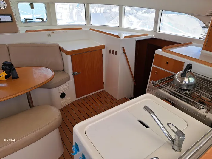 Tortuga Yacht Photos Pics Interior of 2001 Lagoon 380 catamaran with kitchen and seating area.